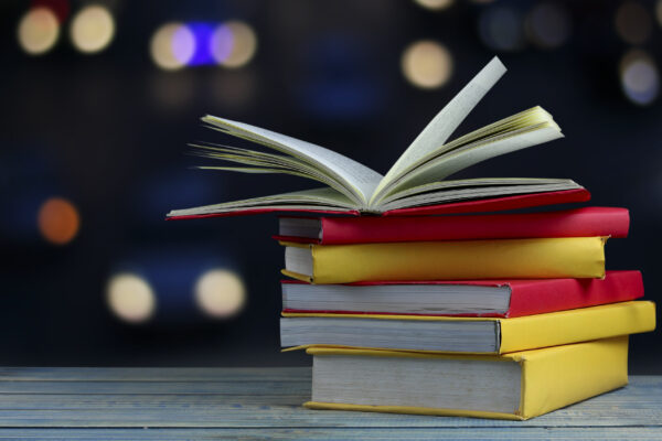 book-on-wood-table-and-soft-blur-bokeh-background-free-photo
